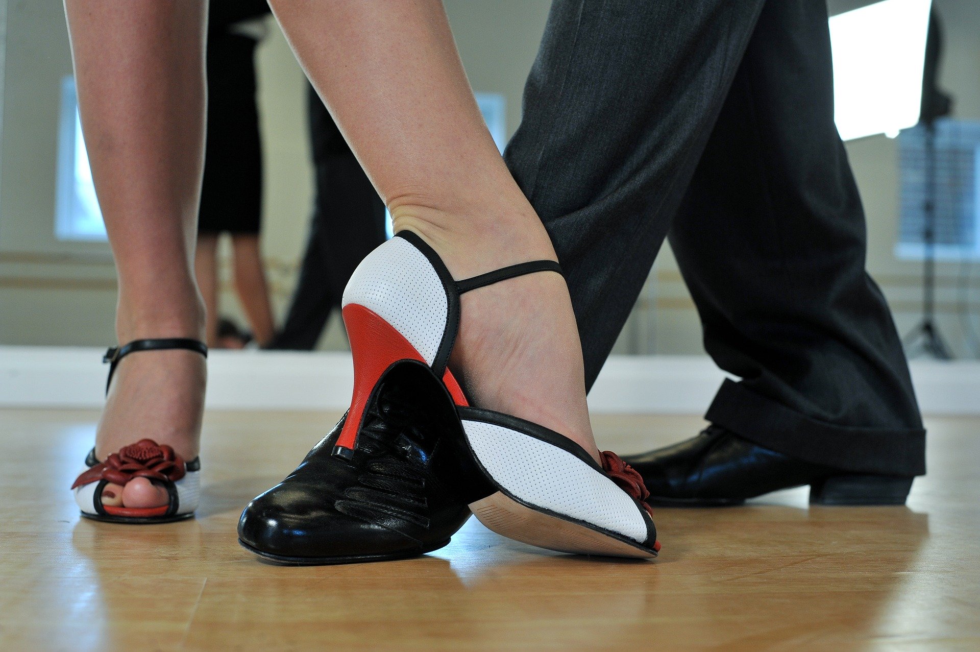 close up of man and woman's dancing feet in dress shoes