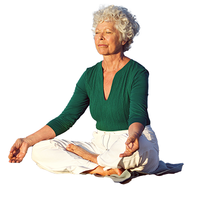 Woman meditating, sitting cross legged with arms resting on knees and fingers touching. 