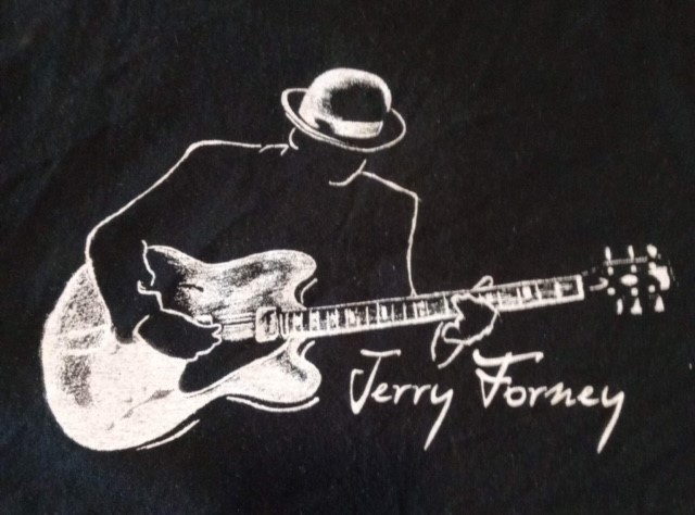 Chalk drawing of man playing guitar wearing hat with the name Jerry Forney written in script. 