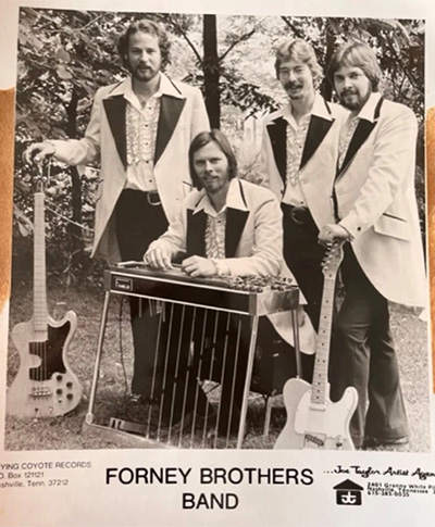 The Forney Brother Band posing for a photograph. 