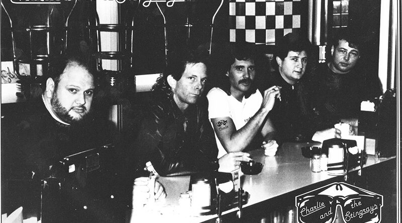 Charlie and the Stingrays Band members sitting at diner countertop.