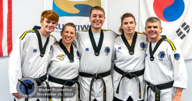 Five students pose for photo after attaining 4th degree Taekwondo blackbelt, which is considered a master.