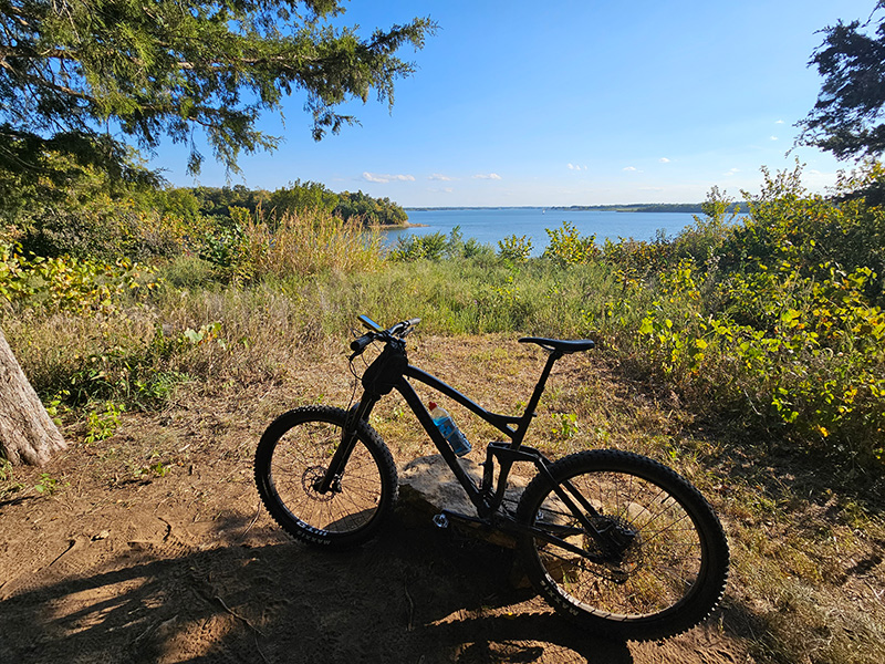 Mountain bike leaning against rock in front of Smithville Lake in Missouri. 