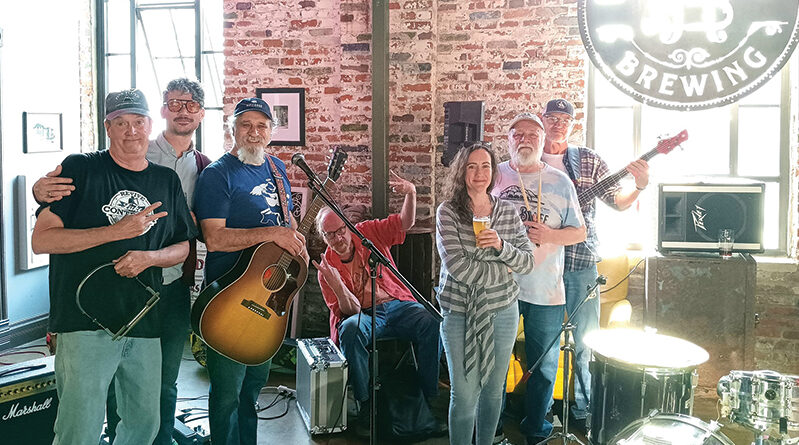 Musicians stand on stage at the River Bluff Brewery in St. Joseph, Missouri.