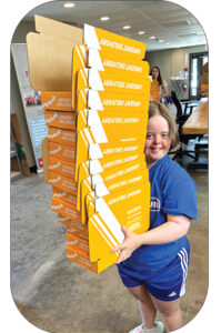 Fulfillment House associate carrying boxes. 